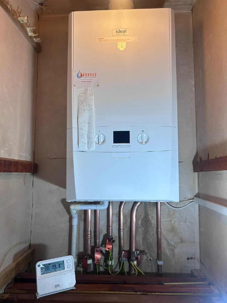 Christopher Konrad working on a boiler and heating installation
